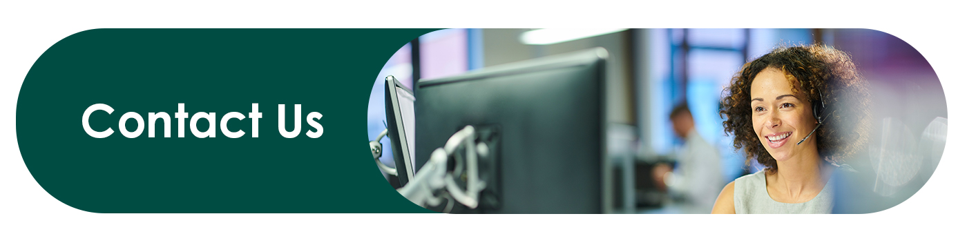 Receptionist sitting at computer and talking on headset providing support to clients and customers